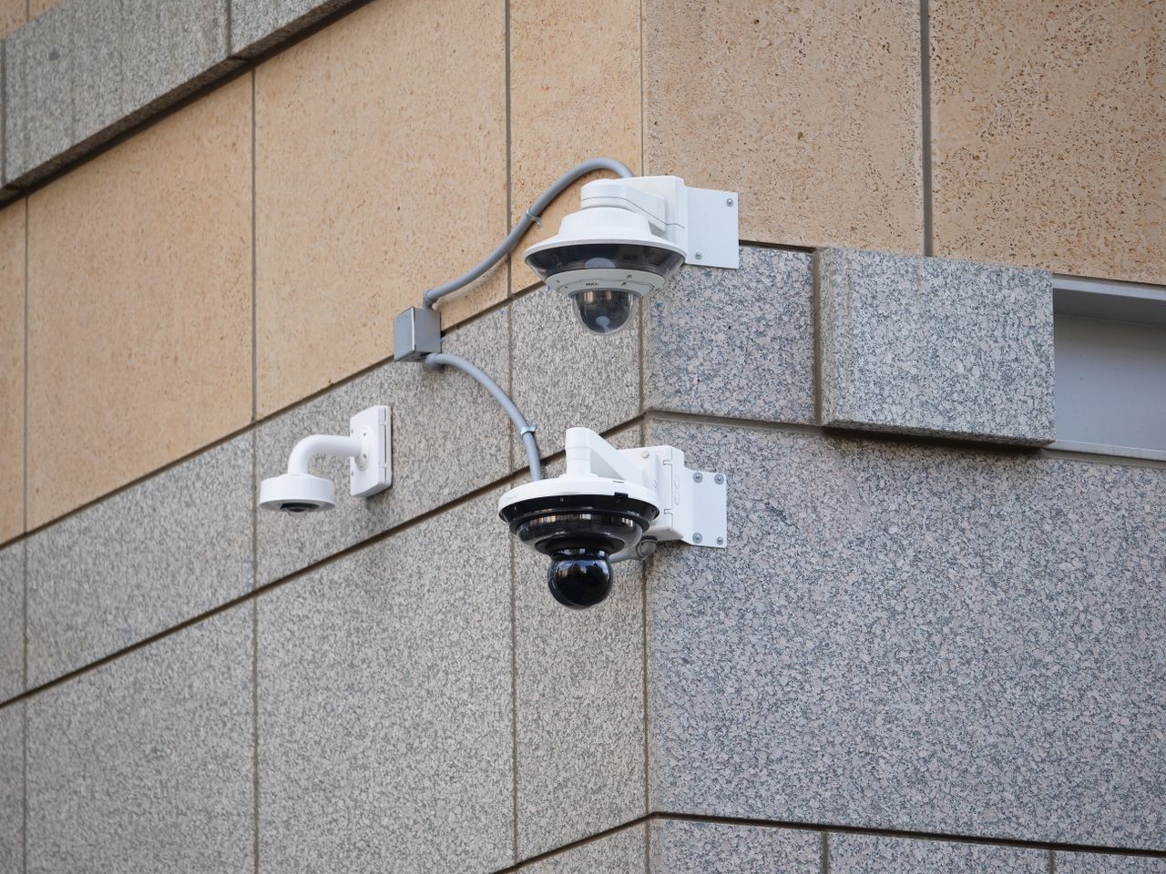 about-01 Security cameras mounted on a building wall providing surveillance and safety.