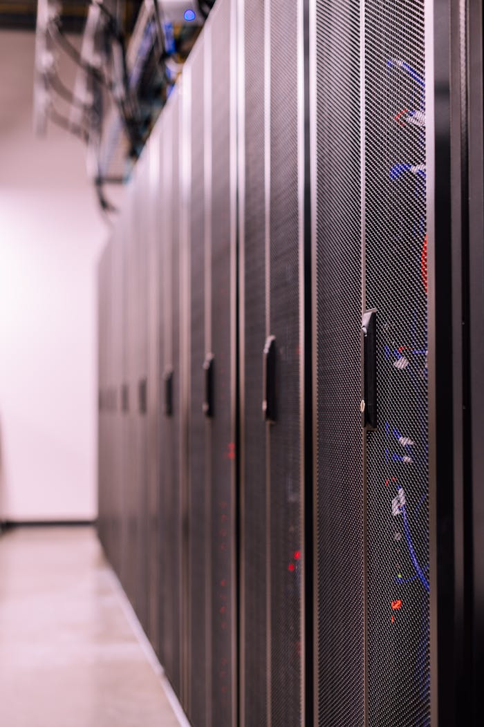 services-01 Row of similar lockers with various optic fiber cables in modern data server room